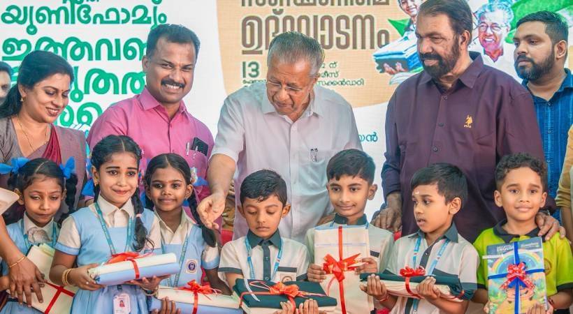 cm distributing books to school students